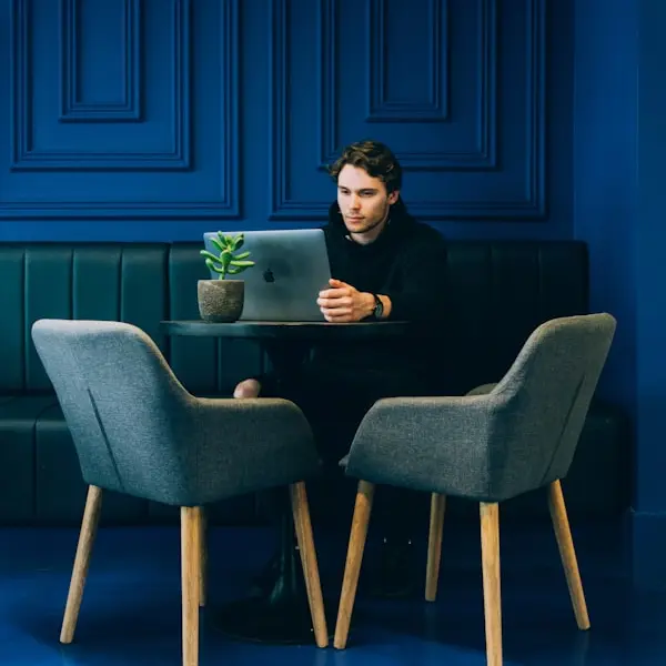 Person staring at laptop sitting on the chair